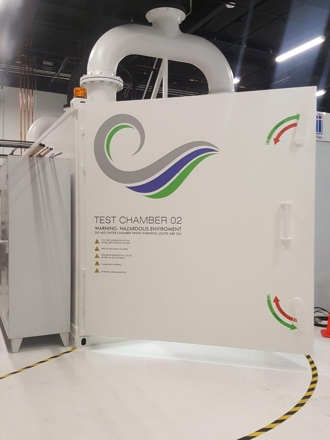 An armored chamber door and overhead ventilation.