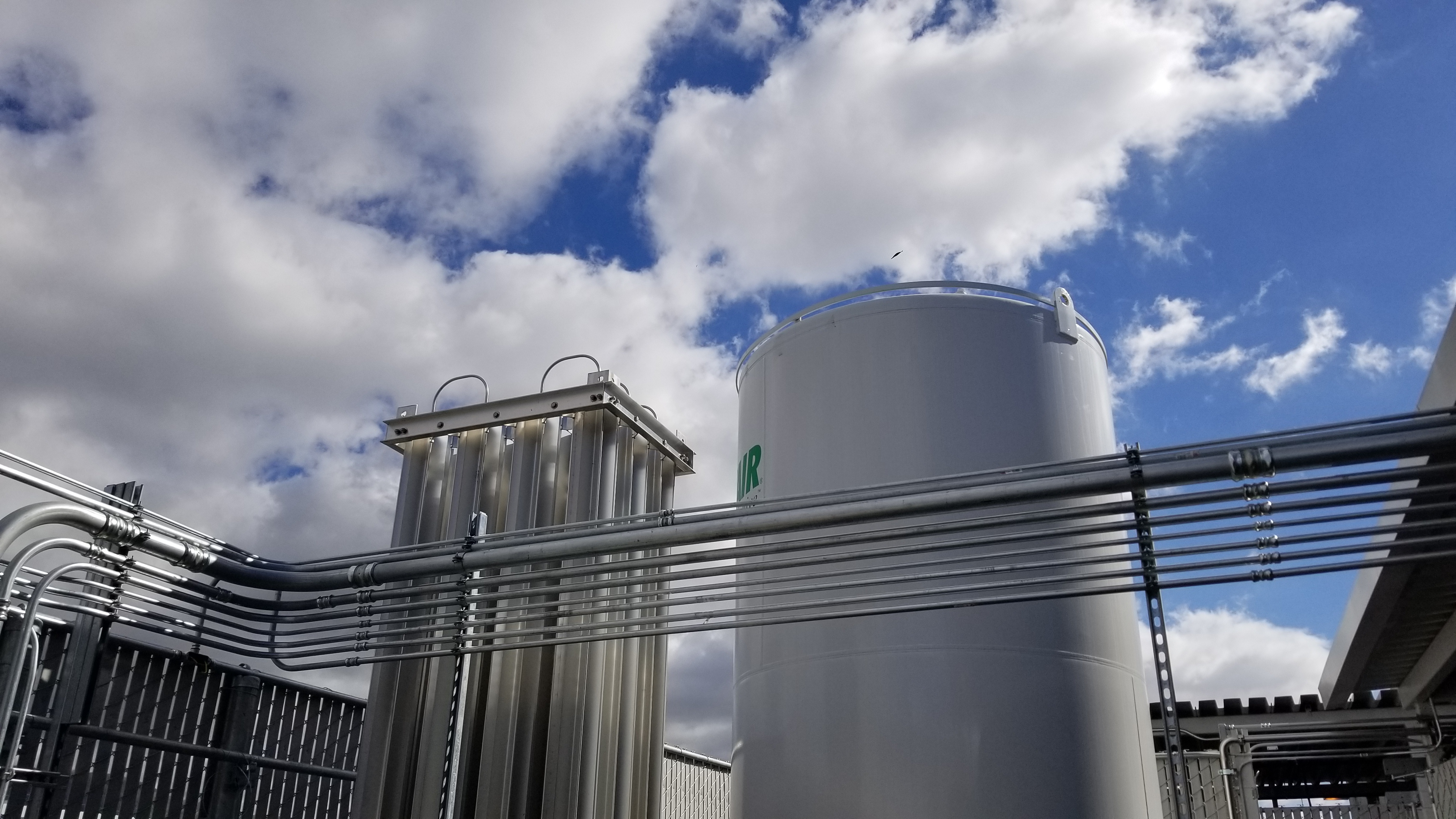 Outdoor bulk gas storage tank and distribution piping serving the laboratories.